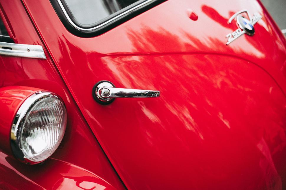 Free Image of Close Up of the Front End of a Red Car 