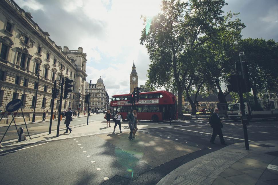 Free Image of Red Double Decker Bus Driving Down Street 