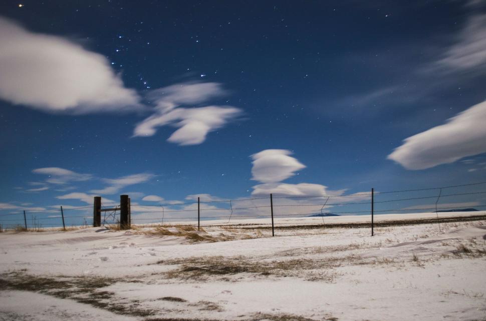 Free Image of Snowy Field With Fence Under Starry Sky 