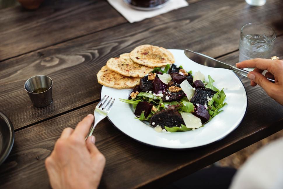 Free Image of Person Sitting at Table With Plate of Food 