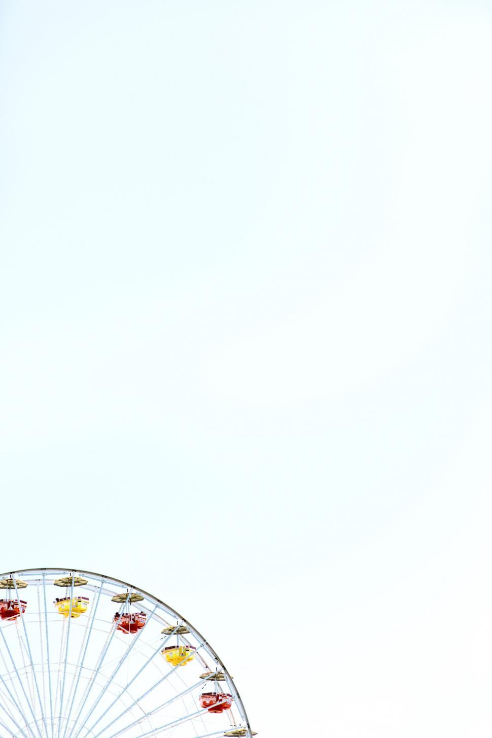Free Image of Ferris Wheel Next to Tall Building 