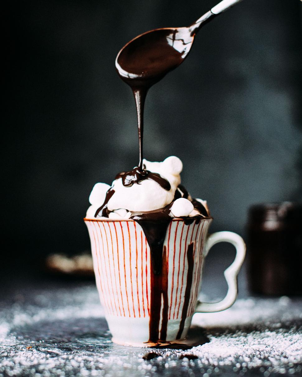 Free Image of Spoon Pouring Chocolate Into Cup of Ice Cream 