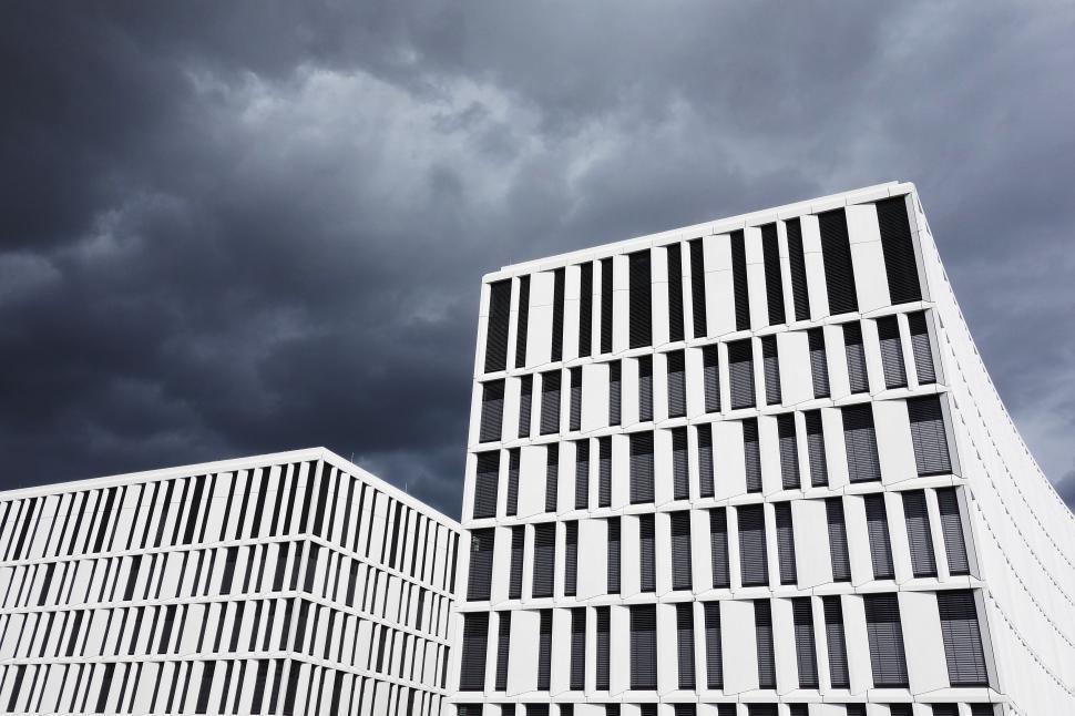 Free Image of Tall White Buildings Under Cloudy Sky 