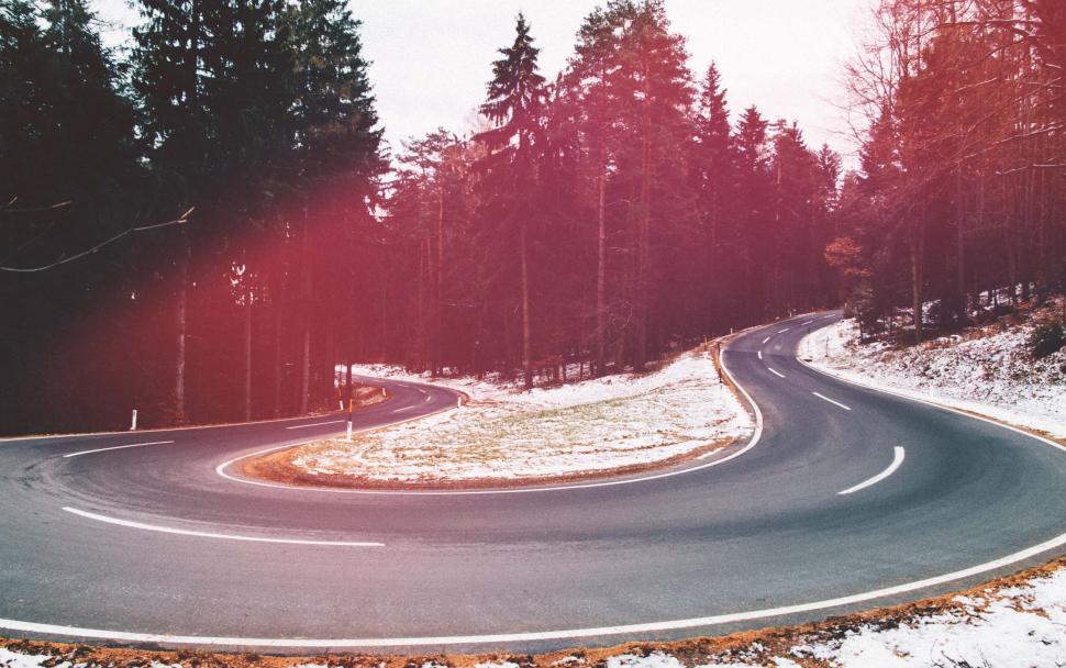 Free Image of Curved Road Through Snowy Forest 