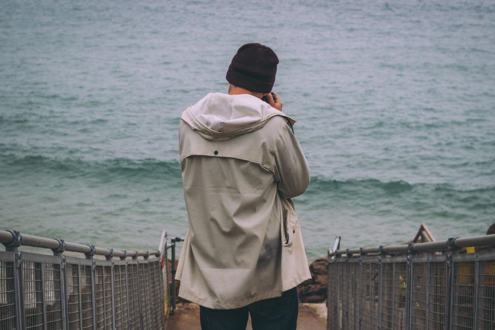 Free Image of Man Standing on Pier Looking at Ocean 