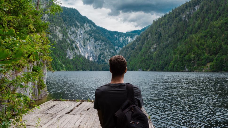 Free Image of Man Sitting on Dock Looking at Mountain Lake 