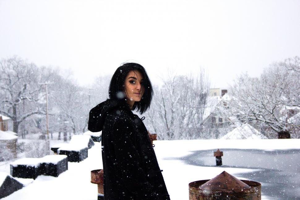 Free Image of Woman in Black Coat Standing in Snow 