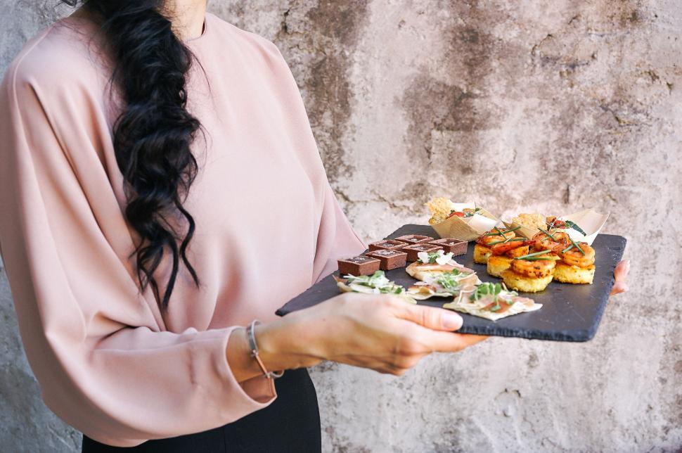 Free Image of Woman Holding a Platter of Food 