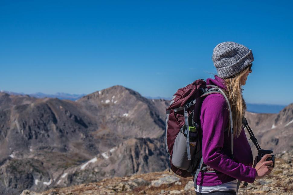 Free Image of Woman Standing on Mountain Top Using Cell Phone 