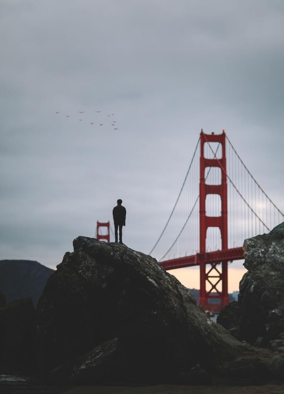 Free Image of Man Standing on Rock Near Golden Gate Bridge 