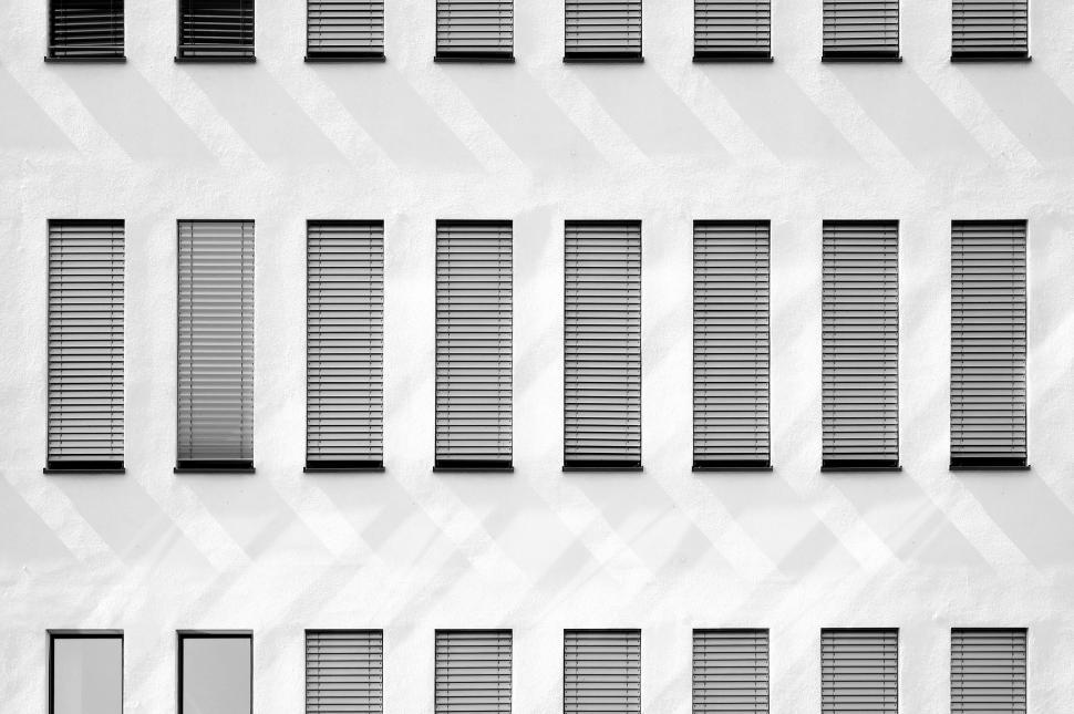 Free Image of White Building With Many Windows and Shutters 