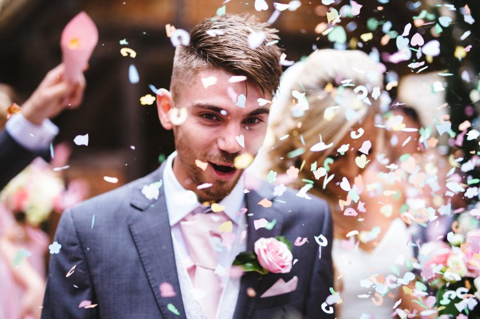 Free Image of Man in Suit Surrounded by Confetti 