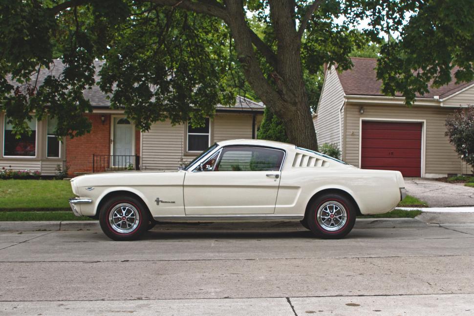 Free Image of White Mustang Parked in Front of House 