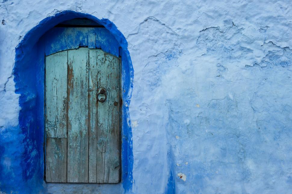 Free Image of Blue Door With Wooden Handle on White Wall 