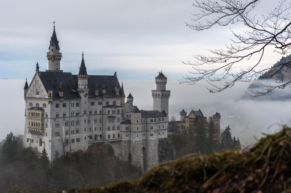 Free Image of Castle Amidst Foggy Forest 