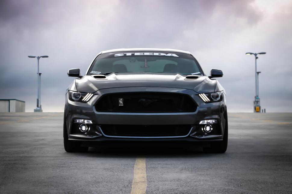 Free Image of Front View of a Black Mustang in a Parking Lot 