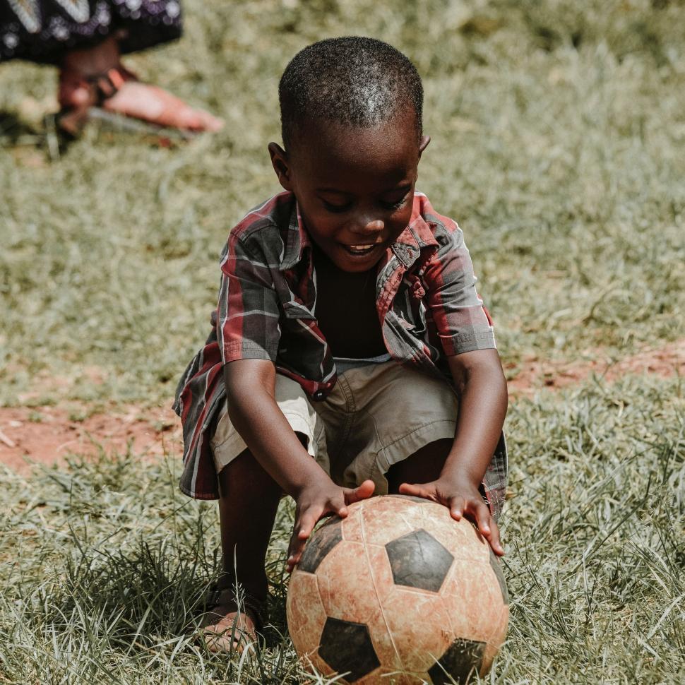 Free Image of Young Boy Playing With a Soccer Ball 