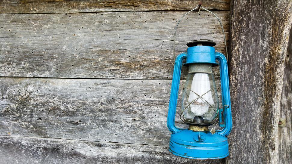 Free Image of Blue Lantern Hanging on Wooden Wall 