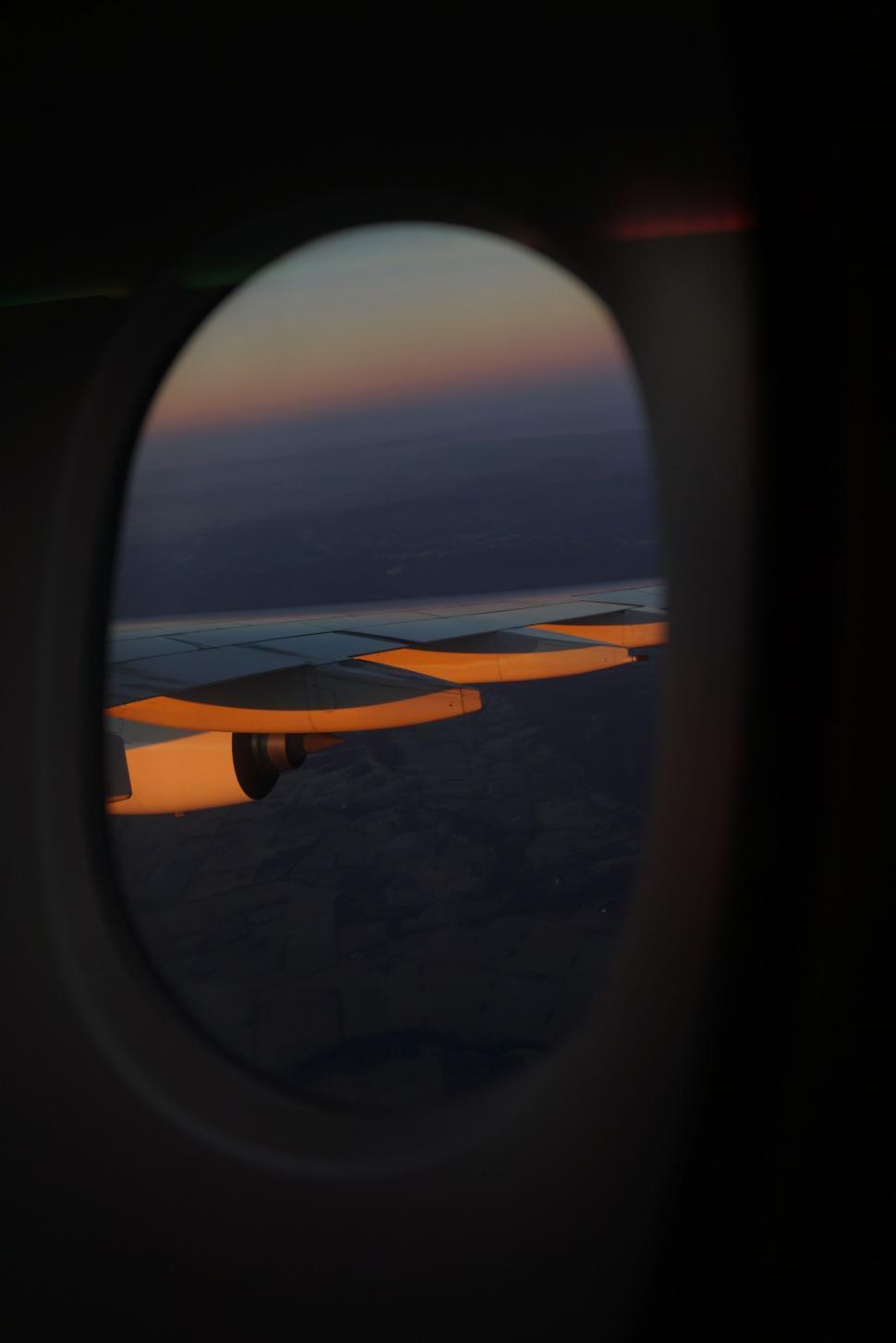 Free Image of A View of the Wing of an Airplane Through a Window 