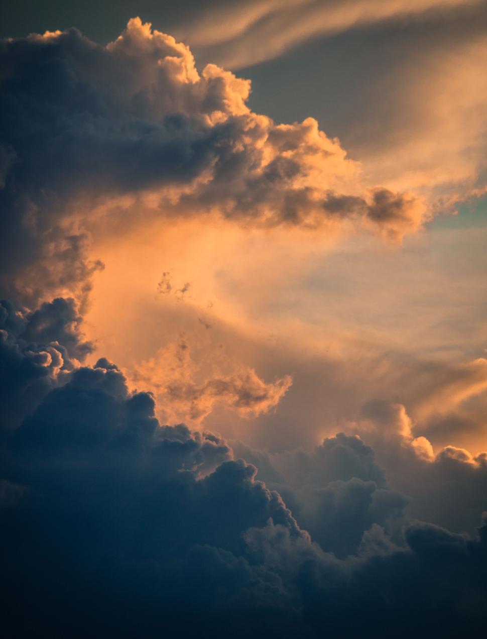Free Image of Plane Flying Through Cloudy Sky at Sunset 