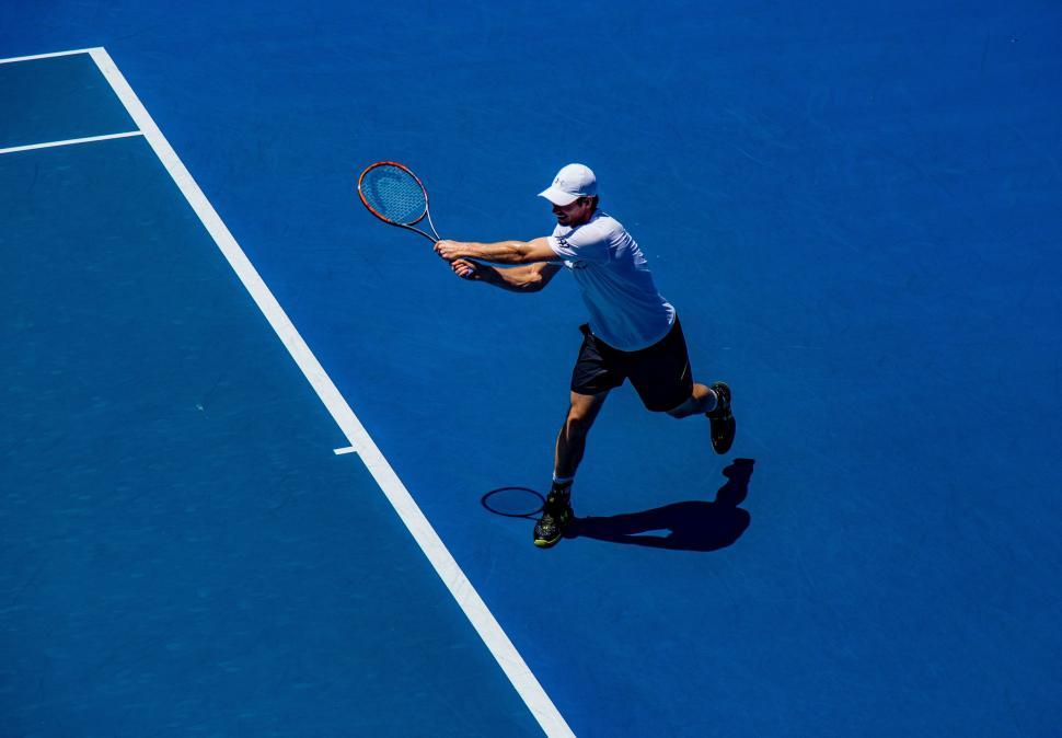 Free Image of Man Swinging Tennis Racquet on Tennis Court 