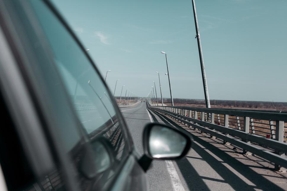 Free Image of Car Driving on Bridge Over Water 