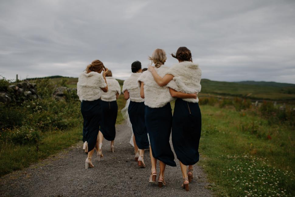 Free Image of Group of Women Walking Down a Dirt Road 