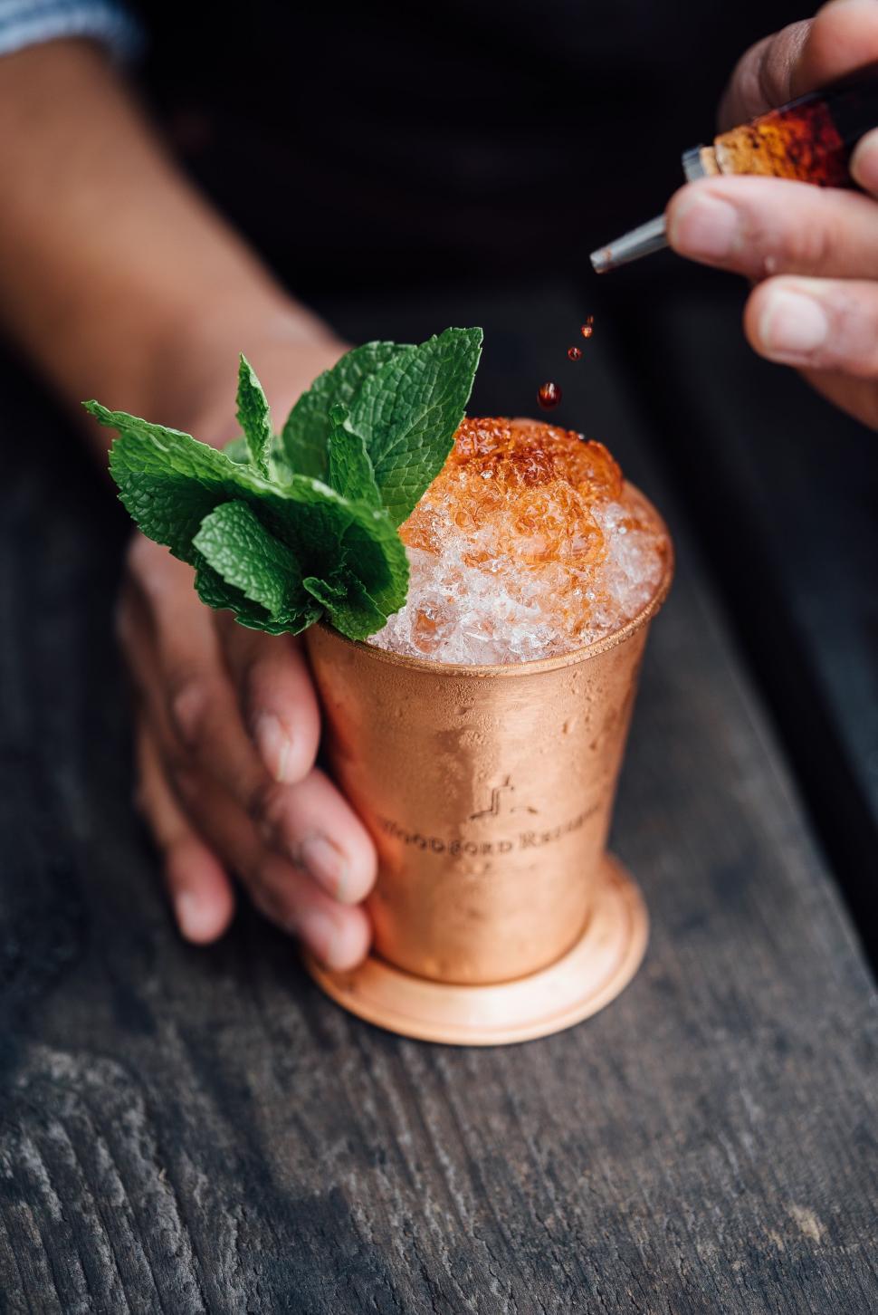 Free Image of Person Holding Copper Cup With Mint Sprig 