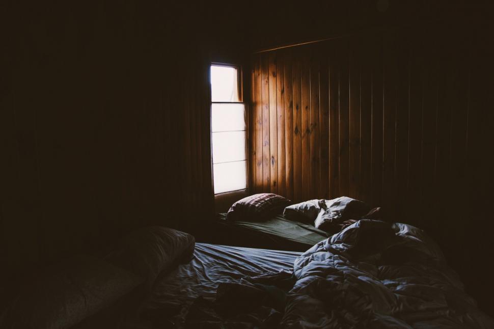 Free Image of Dark Room With Bed and Window 