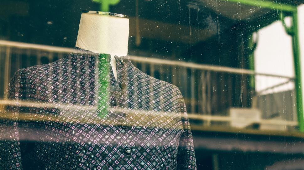 Free Image of Mannequin Wearing Shirt and Tie in Front of Window 