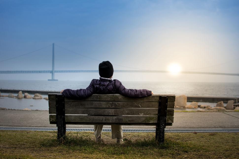 Free Image of Man Sitting on Top of Wooden Bench 