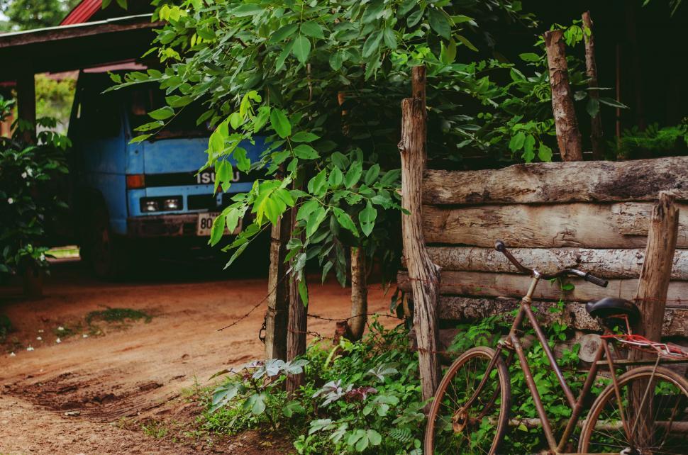 Free Image of Blue Truck Parked Next to Wooden Fence 