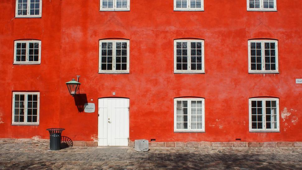Free Image of Red Building With White Door and Windows 