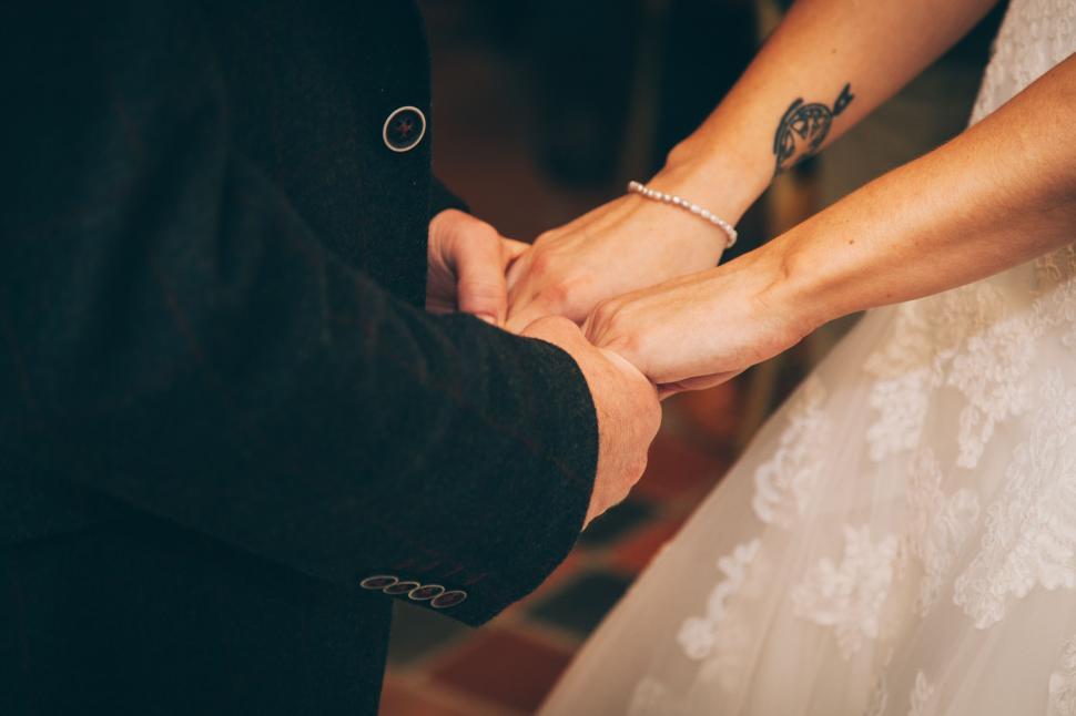 Free Image of Bride and Groom Holding Hands During Wedding Ceremony 