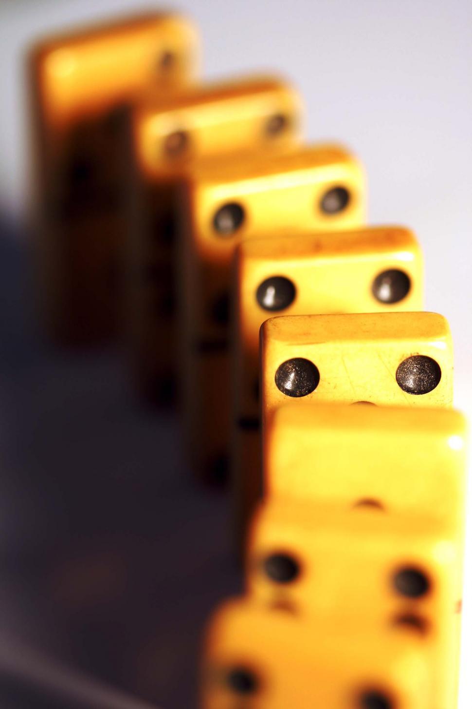 Free Image of A Row of Yellow Dominos on a Table 