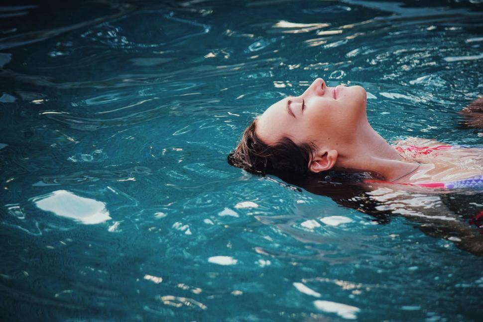 Free Image of Woman Floating in a Pool of Water 