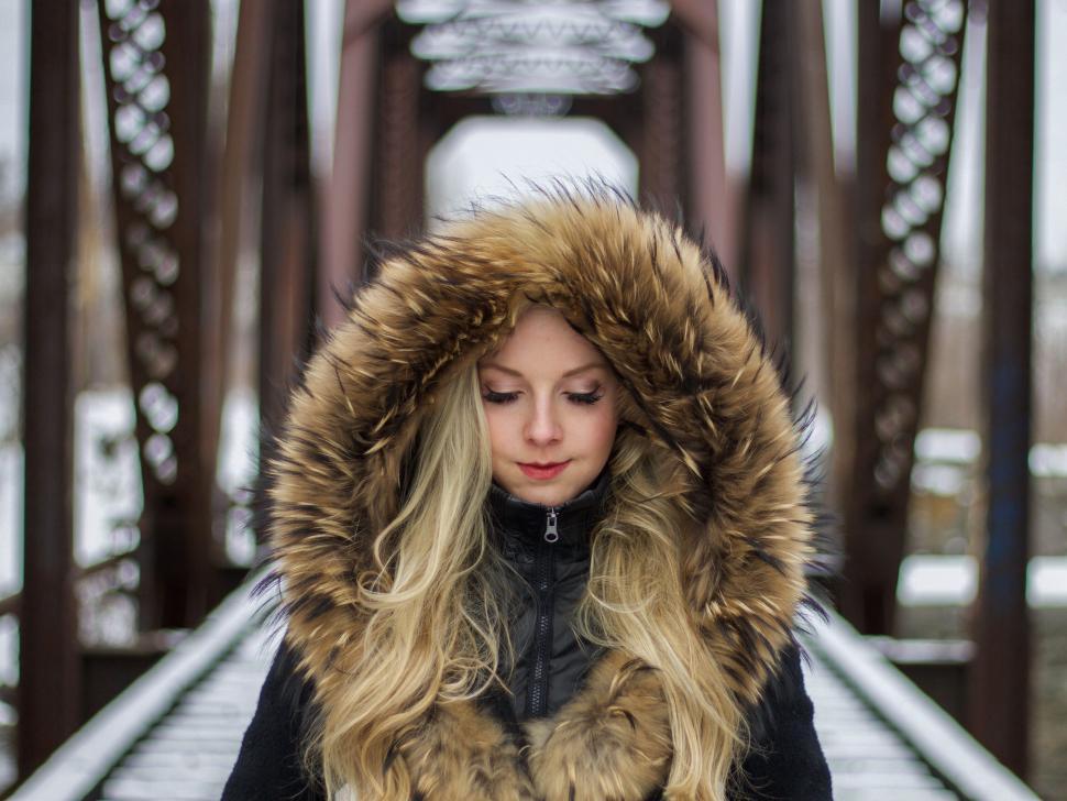 Free Image of Woman Standing on Bridge in Snow 