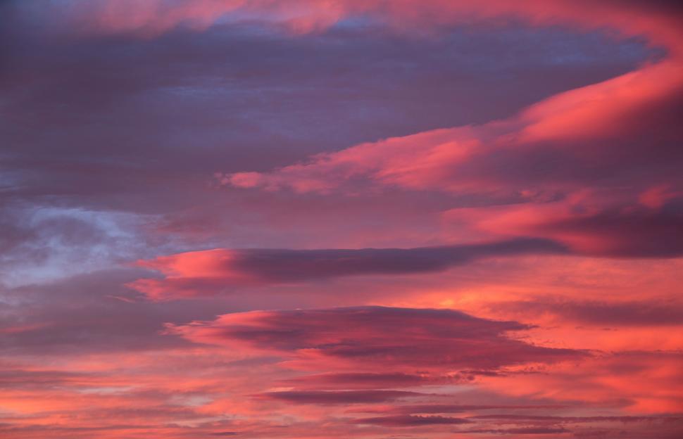 Free Image of Red Sky With Clouds and Plane in Distance 