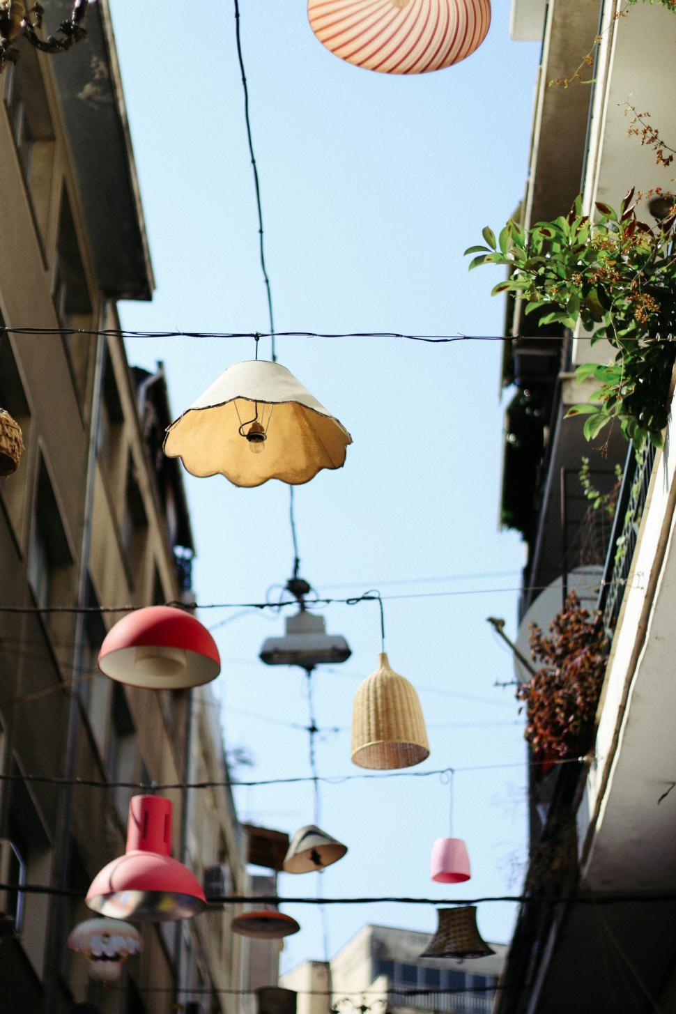 Free Image of Group of Lamps Hanging From Side of Building 