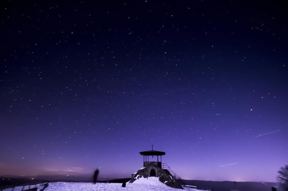 Free Image of Snow Covered Hill Under Purple Sky With Stars 