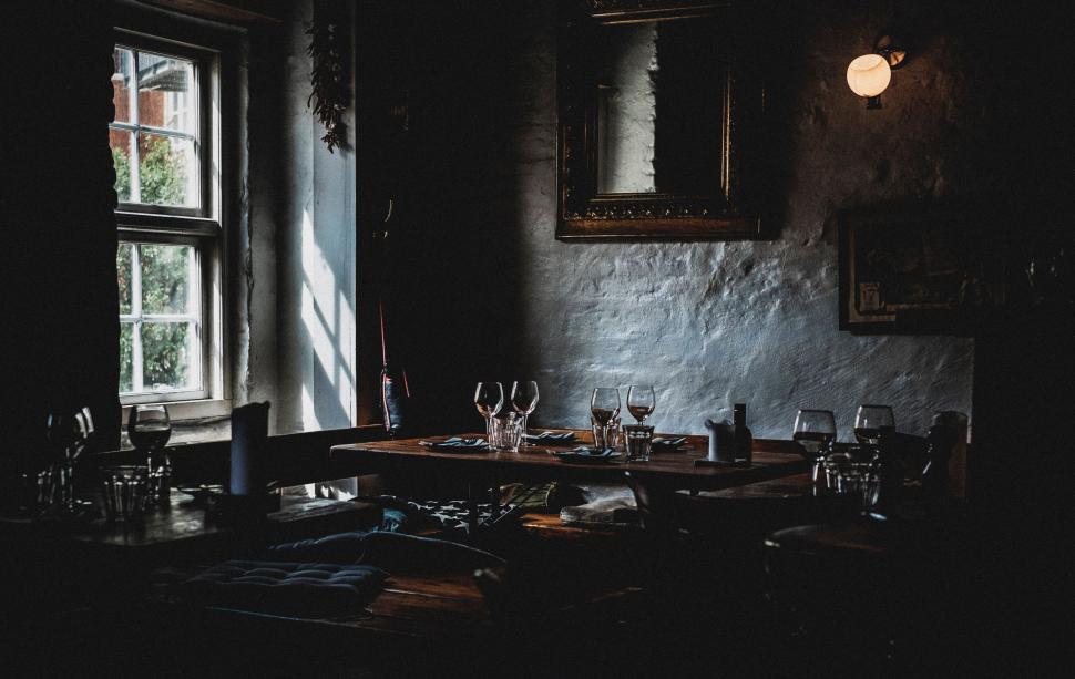 Free Image of Dimly Lit Room With Table and Chairs 
