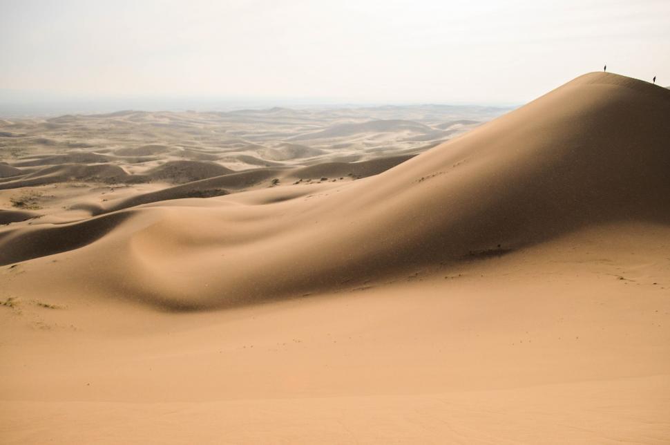 Free Image of Person Standing on Top of a Sand Dune 