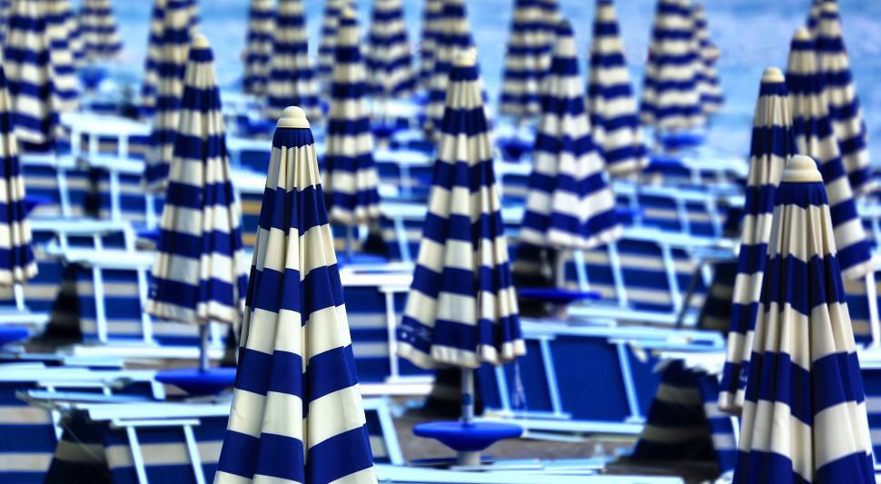 Free Image of Rows of Blue and White Beach Chairs and Umbrellas 