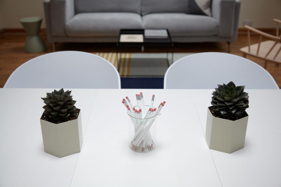 Free Image of White Table With Two Pine Cone-Filled Vases 