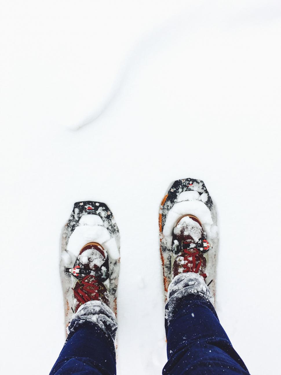 Free Image of Person Standing in Snow With Feet Submerged 