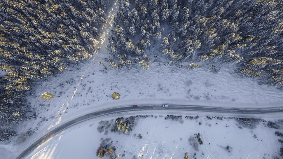 Free Image of Aerial View of Snow Covered Road in Forest 