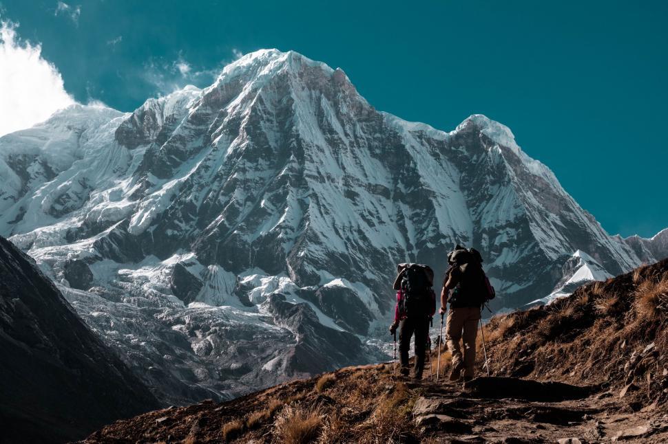 Free Image of Couple Standing on Top of Mountain 