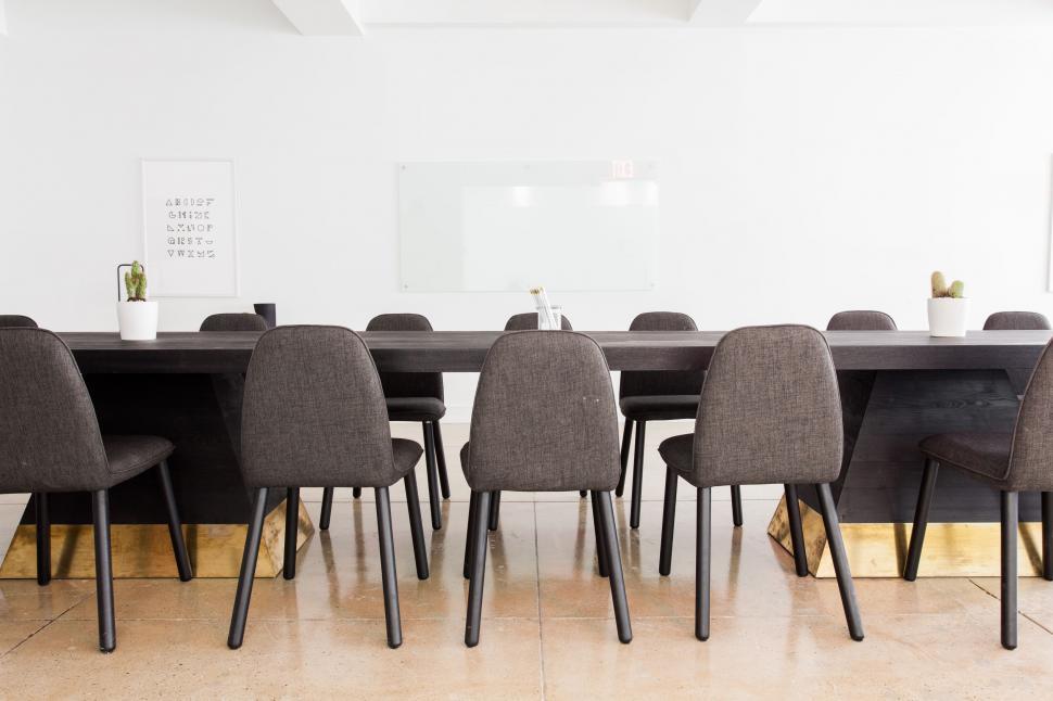 Free Image of Long Table Surrounded by Chairs 