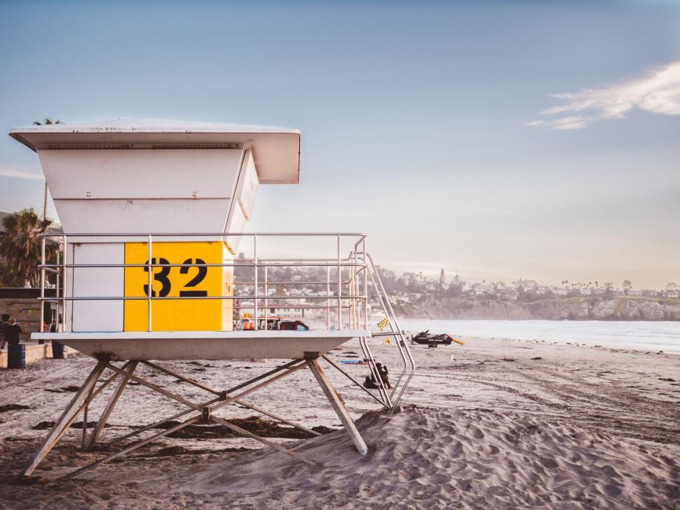 Free Image of Lifeguard Tower With Yellow Sign on Beach 