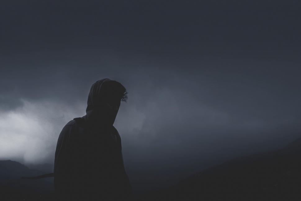 Free Image of Person Standing in the Dark With Dark Sky Background 